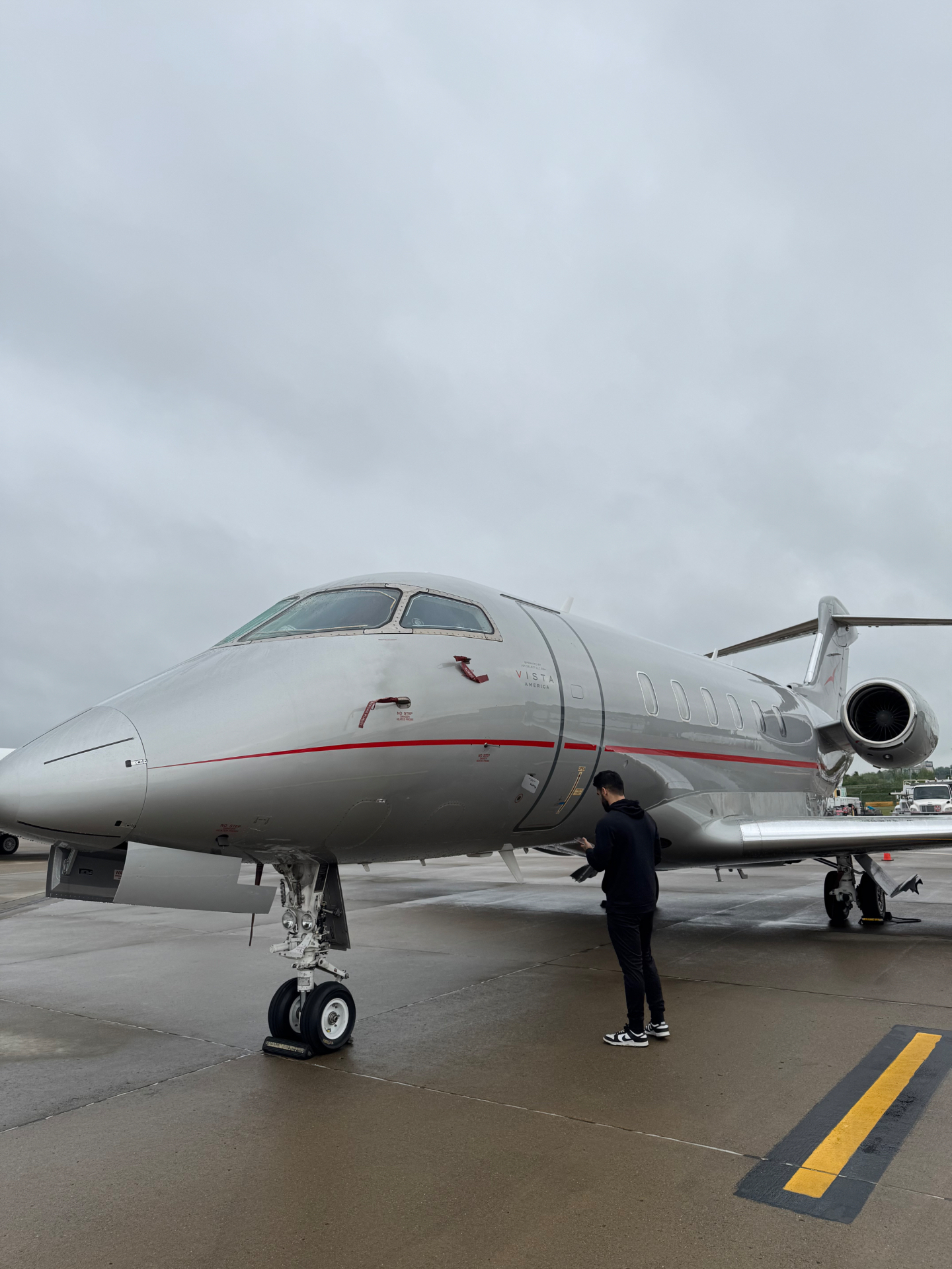 Exterior Cleaning Services Professional aircraft exterior cleaning service — technician washing and polishing private jet fuselage on airport tarmac